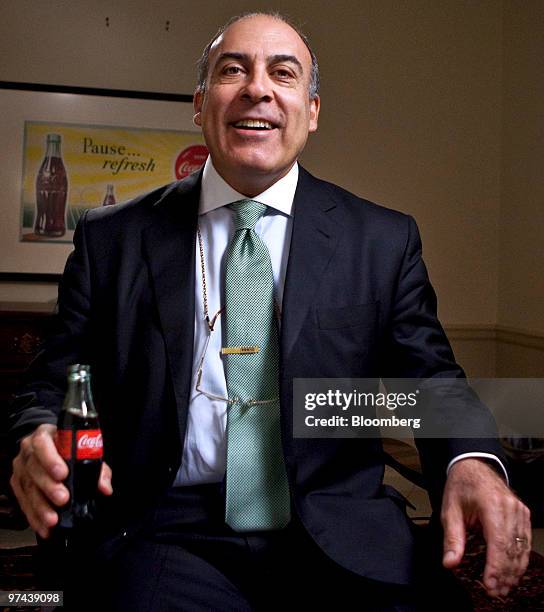 Muhtar Kent, chairman and chief executive officer of Coca-Cola Co., sits for a photo with a bottle of Coca-Cola soda in his hand prior to an...