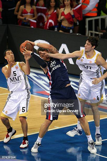 Mario Kasun, #4 of Efes Pilsen Istanbul competes with Pablo Prigioni, #5 of Real Madrid and Alberto Jodar, #4 of Real Madrid during the Euroleague...