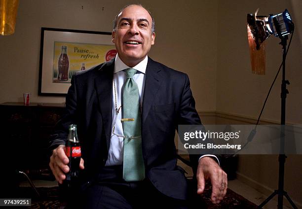 Muhtar Kent, chairman and chief executive officer of Coca-Cola Co., sits for a photo with a bottle of Coca-Cola soda in his hand prior to an...