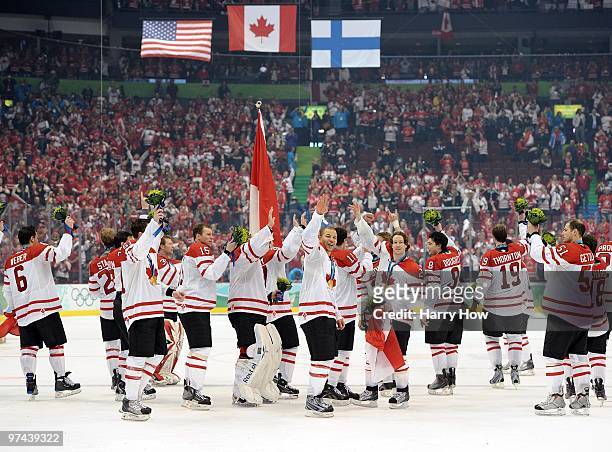 Team Canada players celebrate after receiving the gold medals won during the ice hockey men's gold medal game between USA and Canada on day 17 of the...