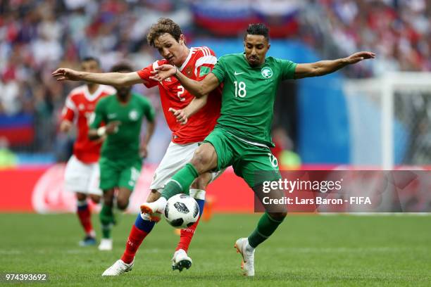 Salem Aldawsari of Saudi Arabia is challenged by Mario Fernandes of Russia during the 2018 FIFA World Cup Russia Group A match between Russia and...