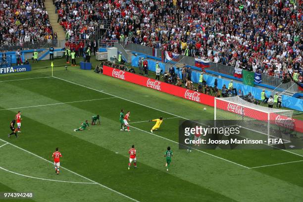 Denis Cheryshev of Russia scores his sides second goal pass Abdullah Almuaiouf of Saudi Arabia during the 2018 FIFA World Cup Russia group A match...