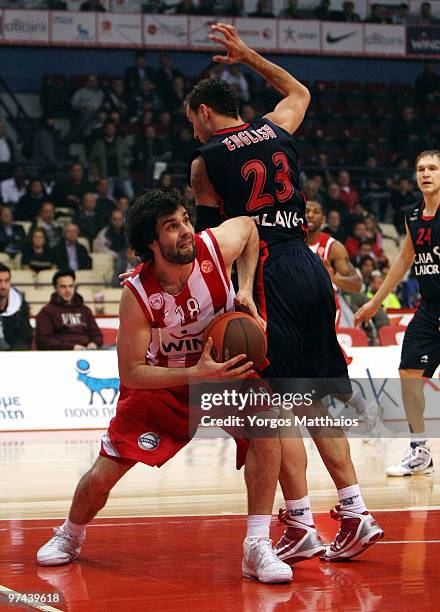 Milos Teodosic, #18 of Olympiacos Piraeus competes with Carl English, #23 of Caja Laboral during the Euroleague Basketball 2009-2010 Last 16 Game 5...