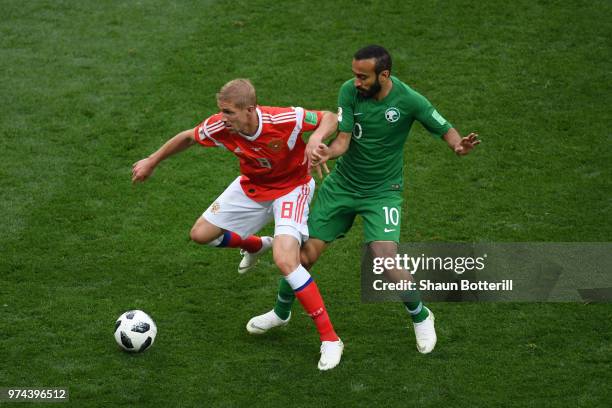 Iury Gazinsky of Russia controls the ball under pressure of Mohammed Alsahlawi of Saudi Arabia during the 2018 FIFA World Cup Russia Group A match...