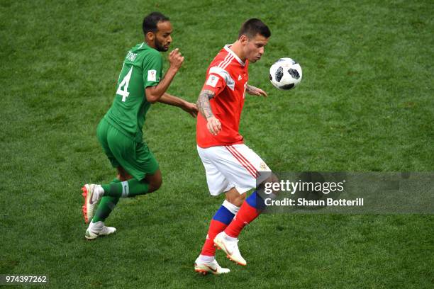 Fedor Smolov of Russia and Abdullah Otayf of Saudi Arabia in action during the 2018 FIFA World Cup Russia Group A match between Russia and Saudi...