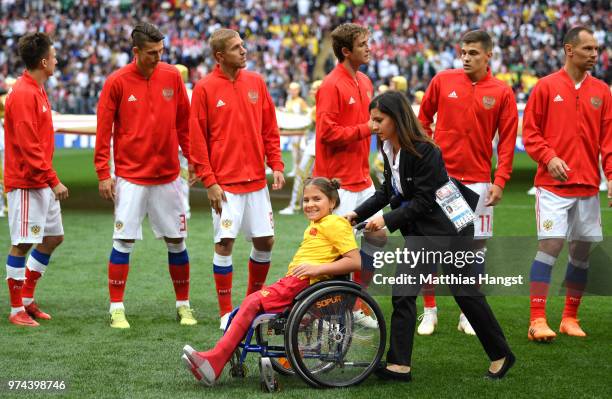 Young fan in her wheelchair is all smiles during the nation anthems prior to the 2018 FIFA World Cup Russia Group A match between Russia and Saudi...