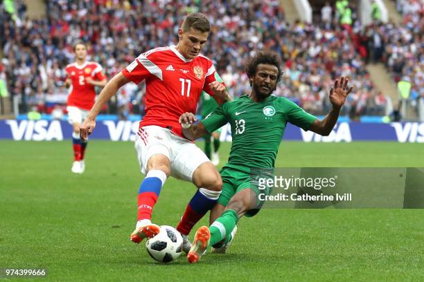Roman Zobnin of Russia is challenged by Yasir Alshahrani of Saudi Arabia during the 2018 FIFA World Cup Russia Group A match between Russia and Saudi...
