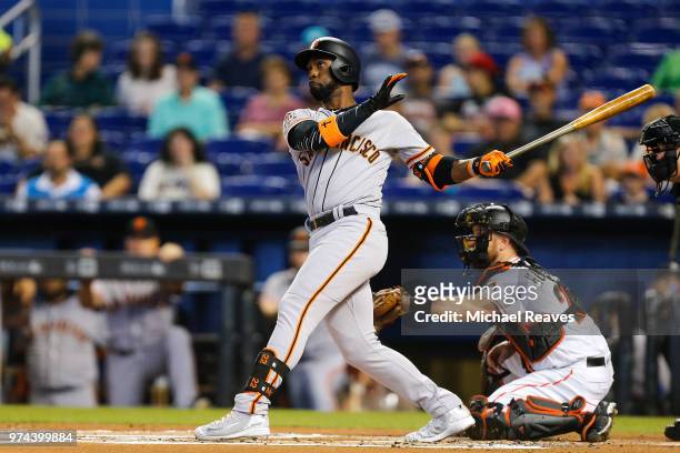 Andrew McCutchen of the San Francisco Giants hits a two-run home run in the first innning against the Miami Marlins at Marlins Park on June 14, 2018...