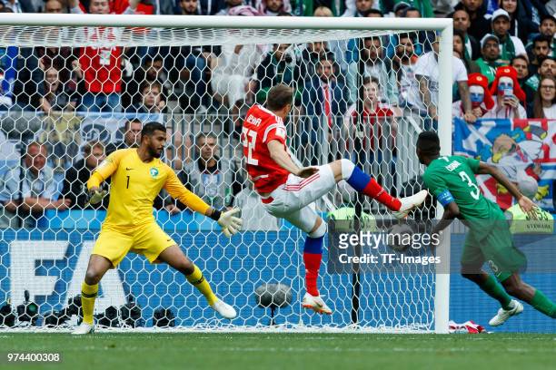 Goalkeeper Abdullah Al-Muaiouf of Saudi Arabia in action and Artem Dzyuba of Russia scores the team`s third goal during the 2018 FIFA World Cup...