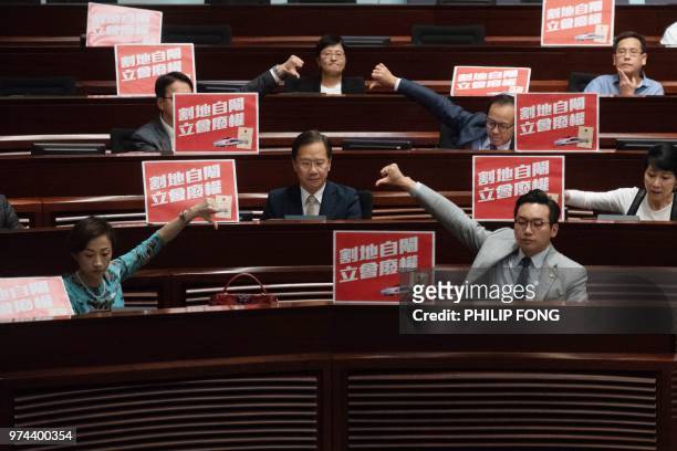 Pro democracy lawmakers react after the Hong Kong Legislative council passed the Guangzhou-Shenzhen-Hong Kong Express Rail Link Bill on June 14,...