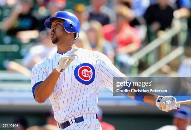 Derrek Lee of the Chicago Cubs hits a solo home run against the Oakland Athletics during the first inning of the MLB spring training game at HoHoKam...