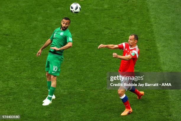 Mohammed Alsahlawi of Saudi Arabia competes with Sergey Ignashevich of Russia during the 2018 FIFA World Cup Russia group A match between Russia and...