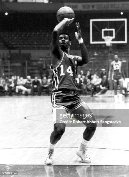 Hall of Fame basketball player Oscar 'The Big O' Robertson, playing for the visiting Cincinnati Royals, shoots a free throw from the foul line,...