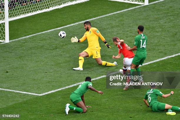 Russia's midfielder Denis Cheryshev scores a goal past Saudi Arabia's goalkeeper Abdullah Al-Mayouf during the Russia 2018 World Cup Group A football...