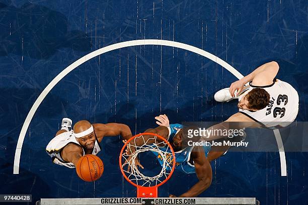 Jamaal Tinsley of the Memphis Grizzlies lays up a shot against Emeka Okafor of the New Orleans Hornets during the game on January 30, 2010 at...
