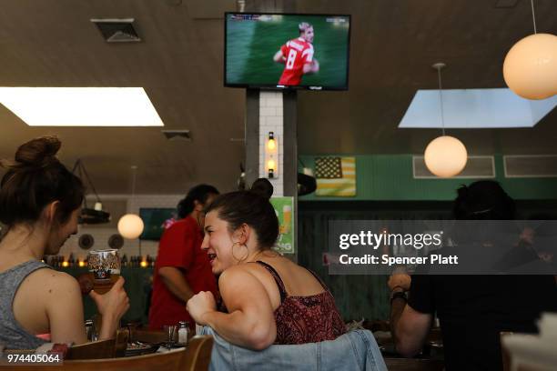 The opening soccer match of the 2018 FIFA World Cup plays at Cafe Max in Russian enclave Brighton Beach June 14, 2018 in the Brooklyn borough of New...