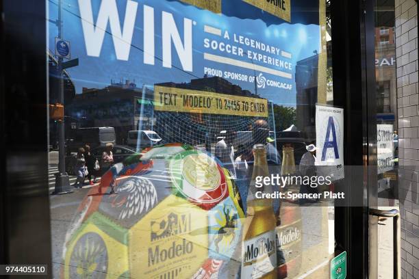 An advertisment for the 2018 FIFA World Cup hangs in a window at Cafe Max in Russian enclave Brighton Beach June 14, 2018 in the Brooklyn borough of...