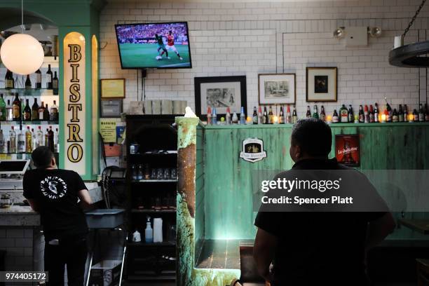 The opening soccer match of the 2018 FIFA World Cup plays at Cafe Max in Russian enclave Brighton Beach June 14, 2018 in the Brooklyn borough of New...