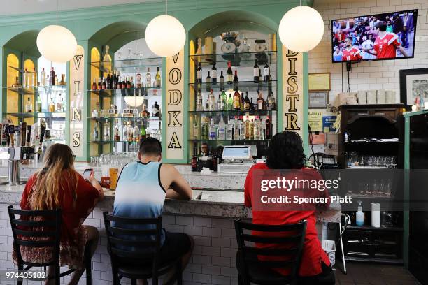 The opening soccer match of the 2018 FIFA World Cup plays at Cafe Max in Russian enclave Brighton Beach June 14, 2018 in the Brooklyn borough of New...