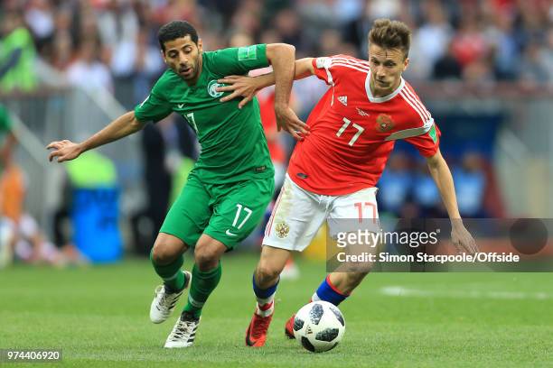 Taisir Al-Jassim of Saudi Arabia and Aleksandr Golovin of Russia battle for the ball during the 2018 FIFA World Cup Russia group A match between...