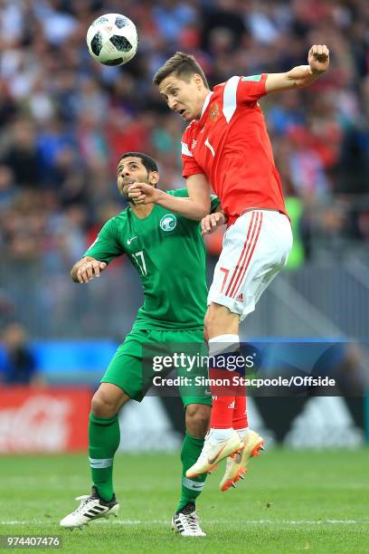 Daler Kuzyayev of Russia beats Taisir Al-Jassim of Saudi Arabia to a header during the 2018 FIFA World Cup Russia group A match between Russia and...