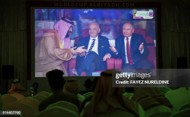 Picture taken on June 14, 2018 in a Saudi football fan tent in the capital Riyadh shows a projector showing the Russia 2018 World Cup Group A...