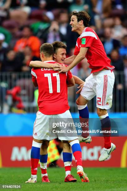 Aleksandr Golovin of Russia celebrates scoring his sides fifth goal with teammates Roman Zobnin and Mario Fernandes during the 2018 FIFA World Cup...