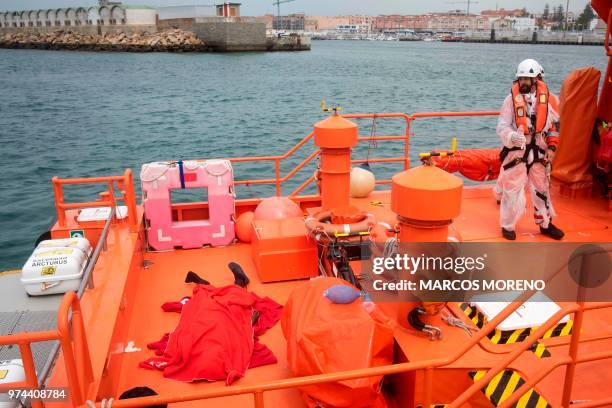 Graphic content / A rescuer looks at the body of a young migrant who drowned at sea upon their arrival aboard a coast guard boat at Tarifa's harbour...