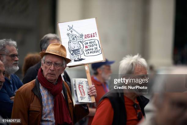 Man holds a placard reading 'Enough ! We're treated like shit'. Several trade unions called retired people to demonstrate against the policies of...