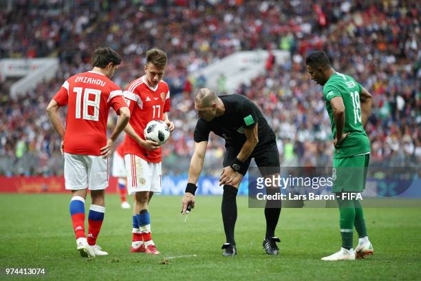 Referee Nestor Pitana uses vanishing spray to mark the pitch for a free kick to be taken during the 2018 FIFA World Cup Russia Group A match between...