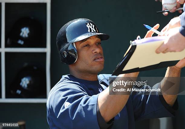 Robinson Cano of the New York Yankees signs an autograph before play against the Philadelphia Phillies March 4, 2010 at the Bright House Field in...