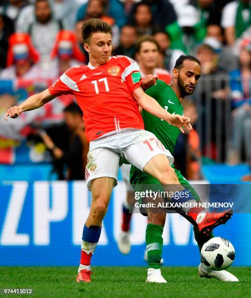 Russia's midfielder Aleksandr Golovin and Saudi Arabia's midfielder Abdullah Otayf vie during the Russia 2018 World Cup Group A football match...