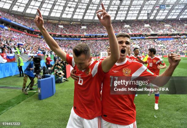 Denis Cheryshev of Russia celebrates with teammate Roman Zobnin after scoring his team's second goal during the 2018 FIFA World Cup Russia Group A...