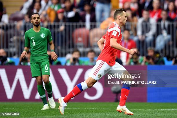 Russia's defender Andrey Semenov celebrates his team's fourth goal past Saudi Arabia's defender Mohammed Al-Breik during the Russia 2018 World Cup...