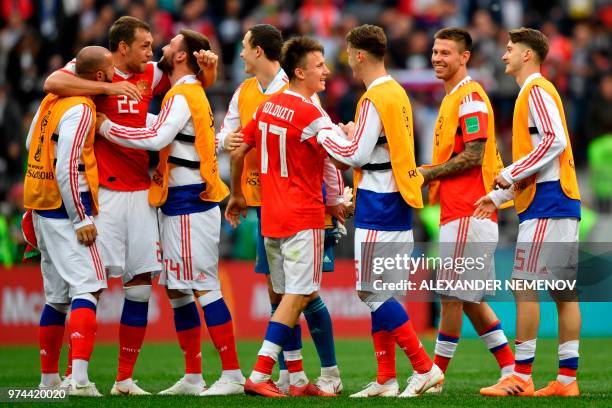Russia's players including goal scorers forward Artem Dzyuba and midfielder Aleksandr Golovin celebrate after the Russia 2018 World Cup Group A...