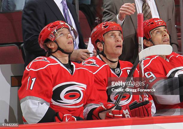 Rod Brind'Amour of the Carolina Hurricanes watches a replay of his first period goal with teammates Zach Boychuk and Tom Kostopoulos during a NHL...