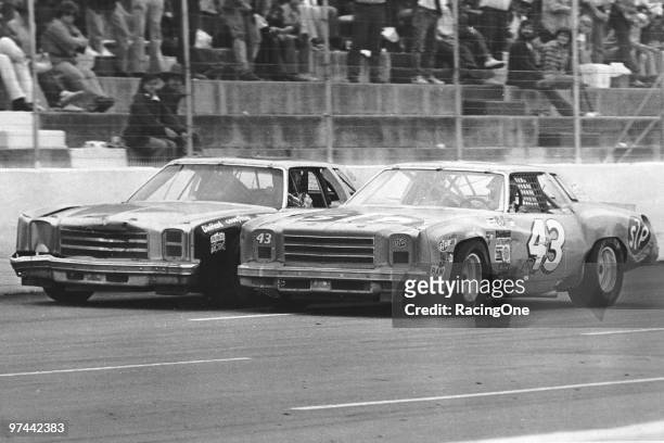 Richard Petty hugs the car of Buddy Baker down the Martinsville straight.