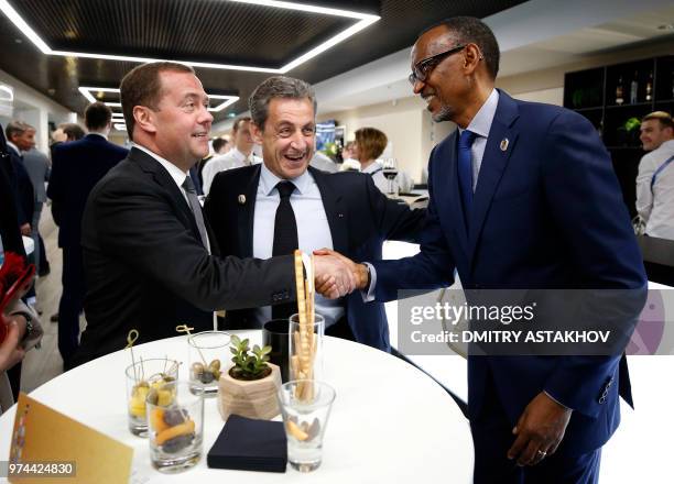 Russian Prime Minister Dmitry Medvedev shakes hands with Rwanda's President Paul Kagame as French former president Nicolas Sarkozy stands nearby...