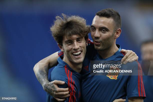 Spain's forward Iago Aspas embraces defender Alvaro Odriozola during a training session with his teammates at the Fisht Olympic Stadium in Sochi on...