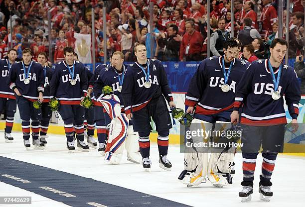Alternate Captain Dustin Brown of USA and his teammates skate toward the locker room after losing 3-2 in the first overtime of their ice hockey men's...