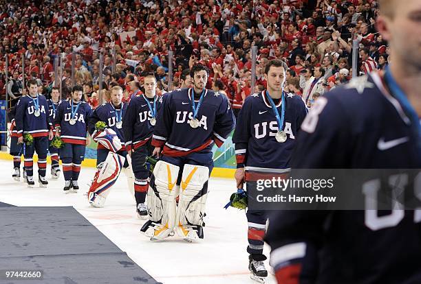 Goaltender Ryan Miller of USA skates off the ice after losing 3-2 in the first overtime of their ice hockey men's gold medal game against Canada on...