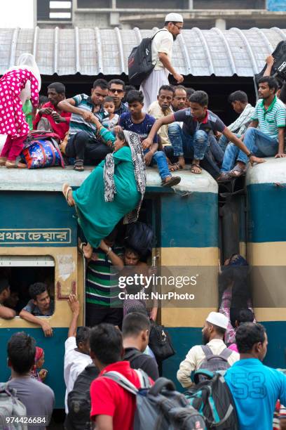 Bangladeshis cram onto a train as they travel back home to be with their families ahead of the Muslim festival of Eid al-Fitr in Dhaka , Bangladesh...