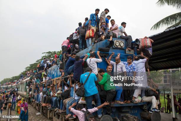 Bangladeshis cram onto a train as they travel back home to be with their families ahead of the Muslim festival of Eid al-Fitr in Dhaka , Bangladesh...