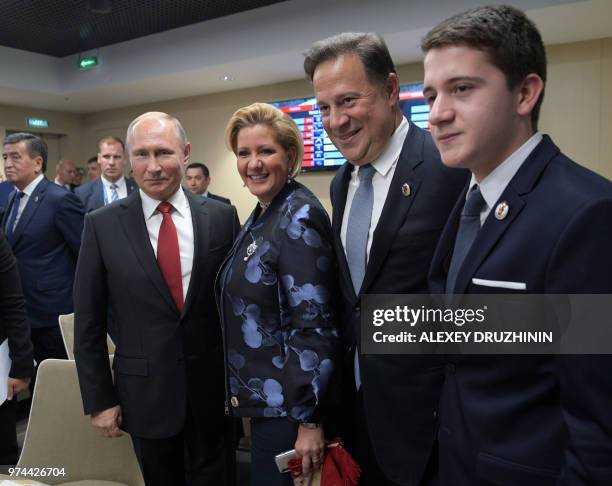 Russian President Vladimir Putin poses with Panama's President Juan Carlos Varela, Panama's first lady Lorena Castillo de Varela and their son at the...