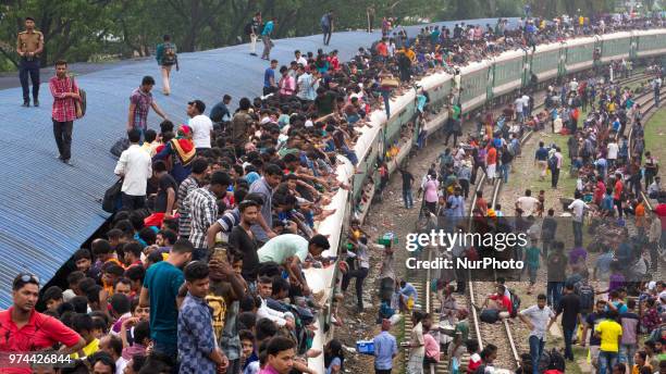 Bangladeshis cram onto a train as they travel back home to be with their families ahead of the Muslim festival of Eid al-Fitr in Dhaka , Bangladesh...