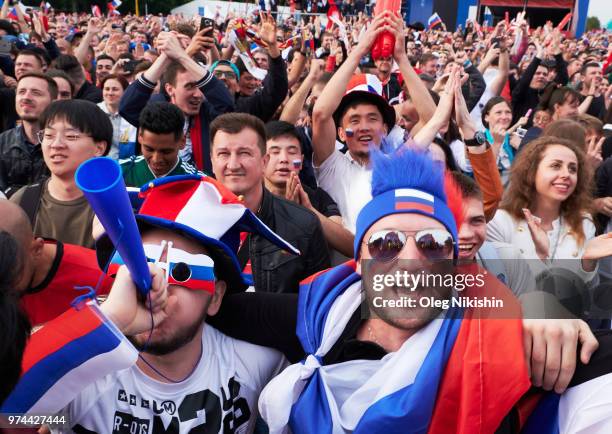 Football fans from across the globe gather at the official FIFA Fan Fest at Moscow State University to watch the first World Cup game between Russia...