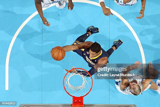 Danny Granger of the Indiana Pacers shoots a layup against Peja Stojakovic of the New Orleans Hornets during the game at New Orleans Arena on...