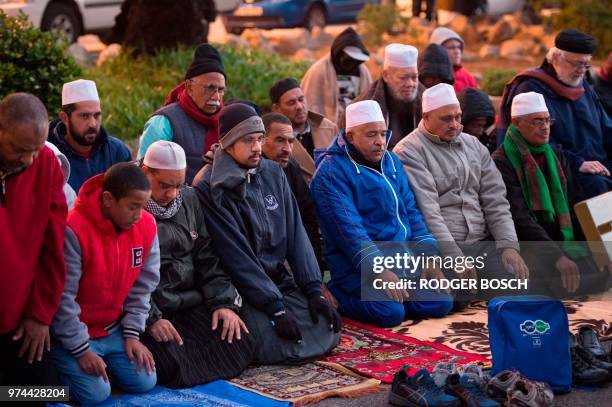 Muslim men pray at Seapoint Promenade, a popular public area next to the sea, before trying to sight the new moon, which will signify the end of the...