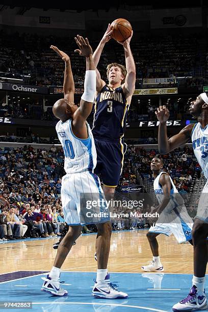 Troy Murphy of the Indiana Pacers goes up for a shot against David West of the New Orleans Hornets during the game at New Orleans Arena on February...