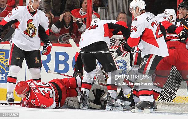 Brian Elliott of the Ottawa Senators makes the save despite traffic created by Jussi Jokinen of the Carolina Hurricanes during a NHL game on March 4,...